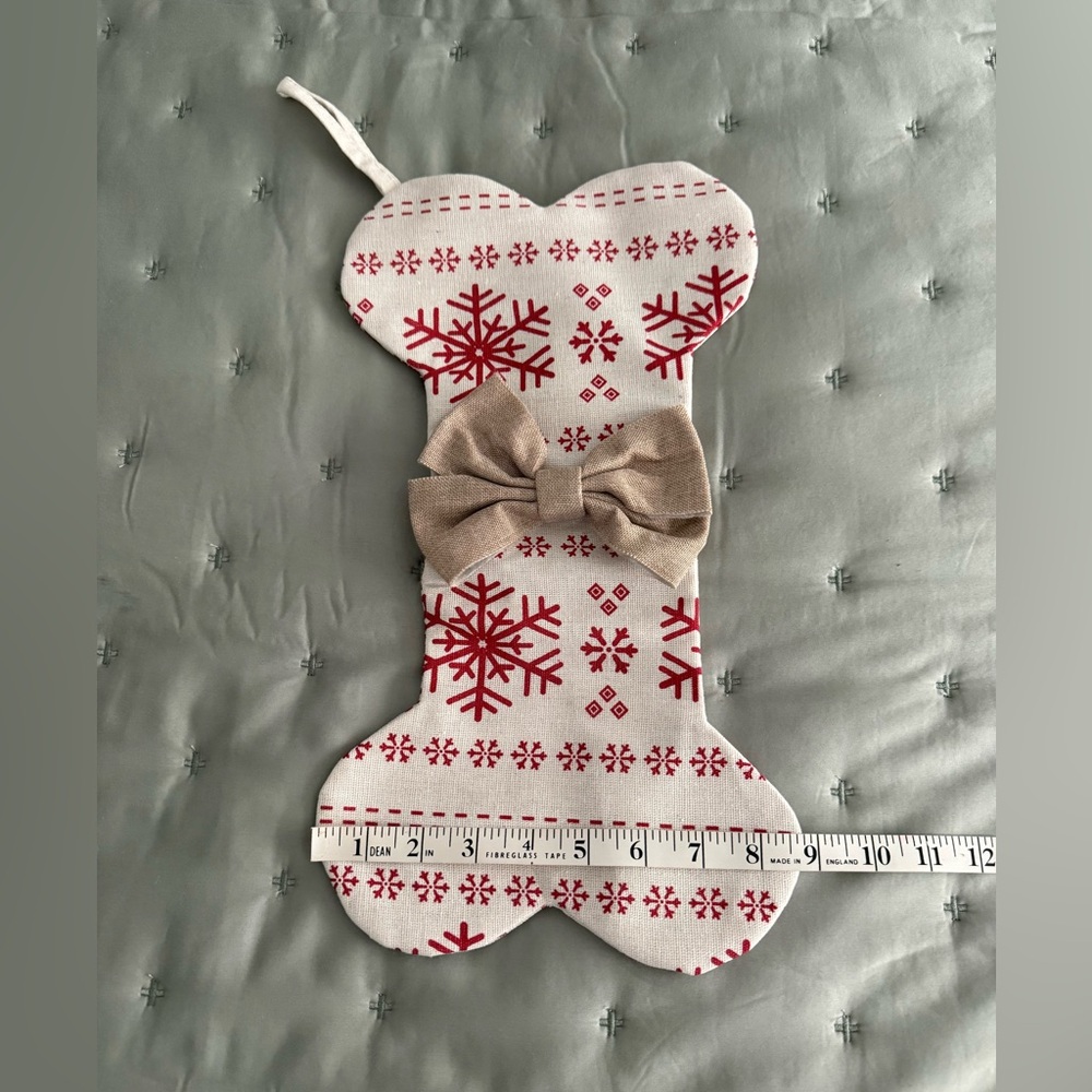 Dog bone stocking, natural with festive red print & tan bow on front.